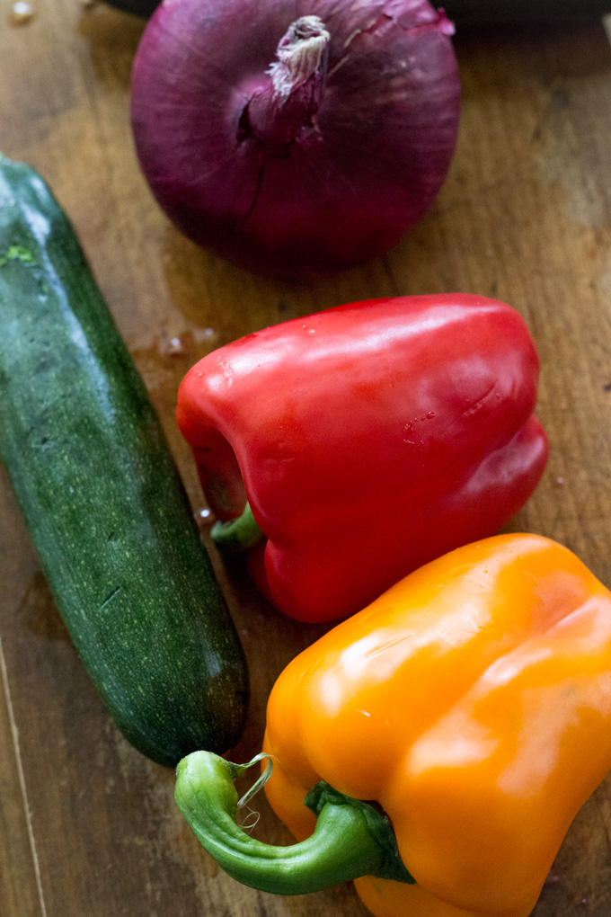 closer view of a Yellow Bell Pepper, Red Bell Pepper, Cucumber and an Onion