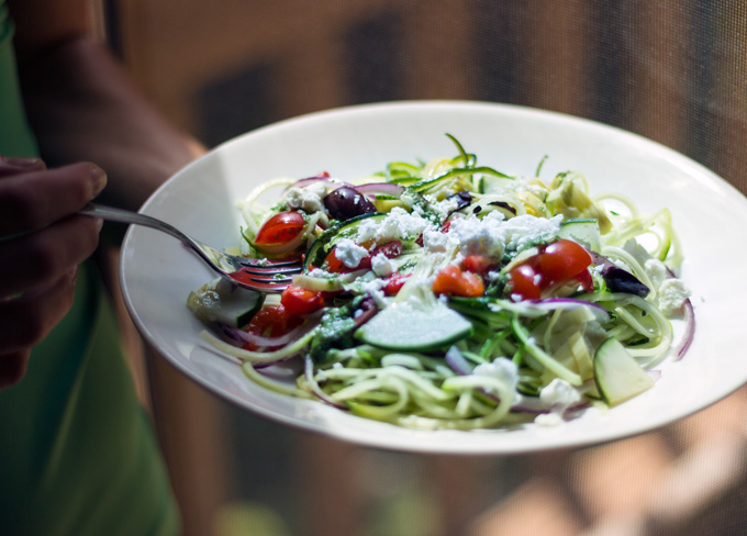 Side view image of Mediterranean Zucchini Noodle Salad in a plate