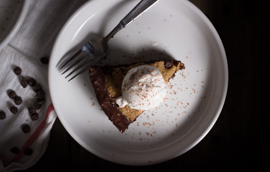 Top View of Sliced Paleo Skillet Brookie with Ice Cream in a Plate with Fork
